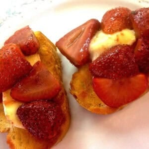 Overhead view of Two Strawberry and Brie Crostinis on a plate