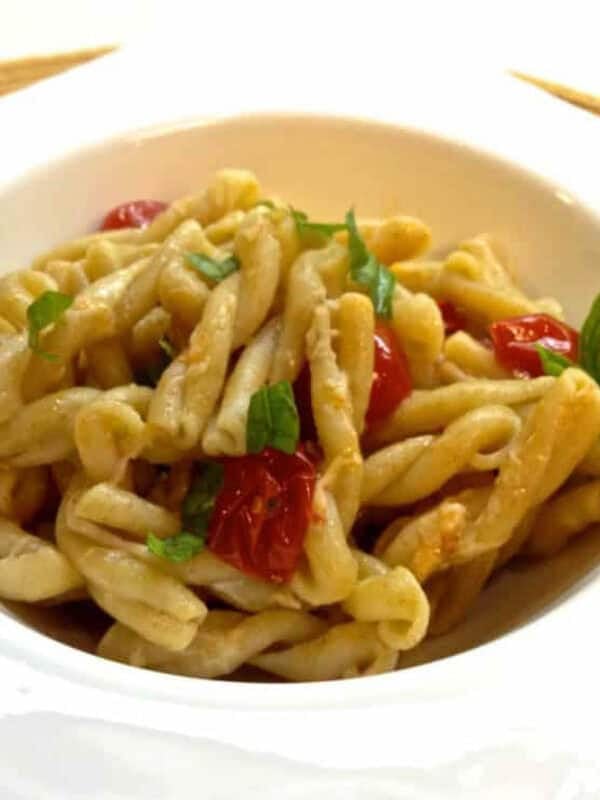 A square bowl of Gemelli Pasta with Tomatoes, Basil and Garlic