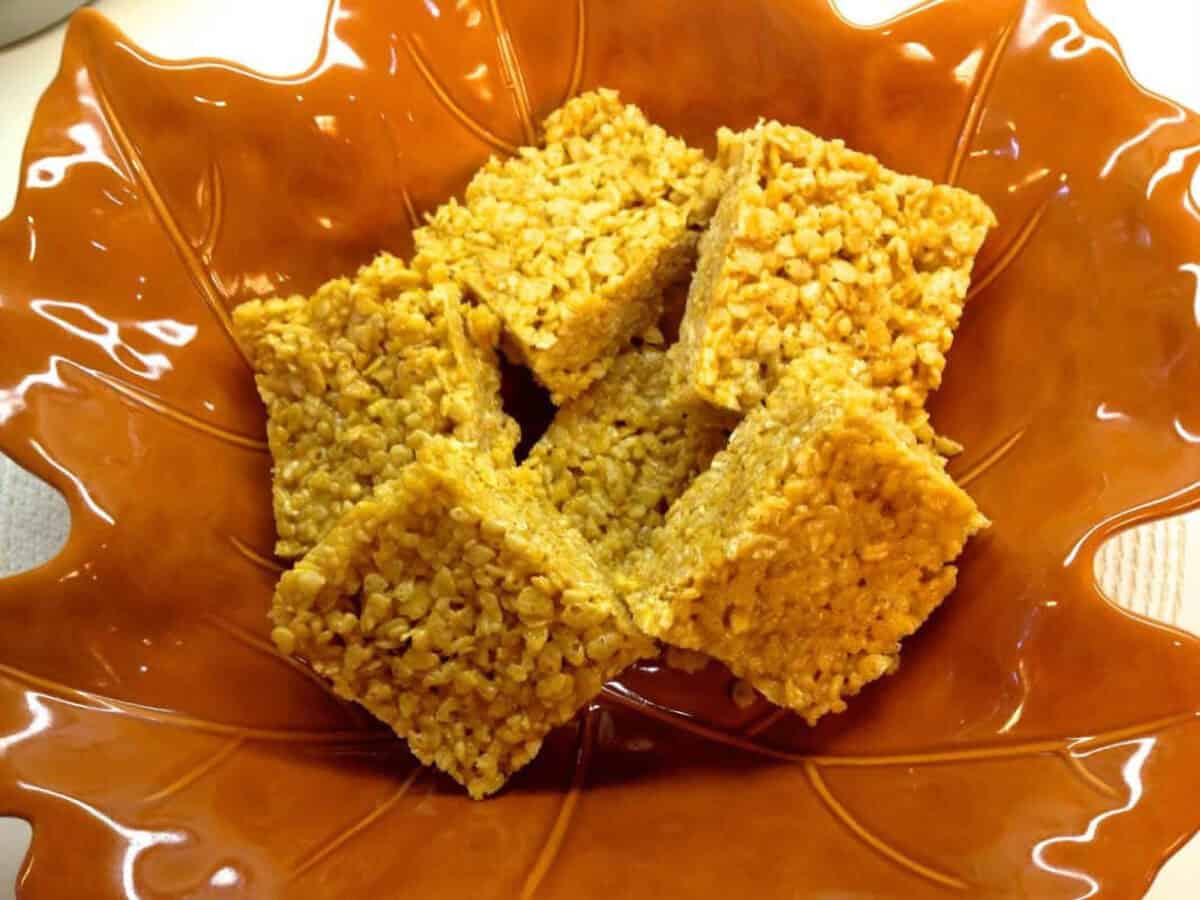 Pumpkin Spice Rice Krispies Treats An overhead view of Six Pumpkin Spice Rice Krispies Treats in a large leaf-shaped serving bowl
