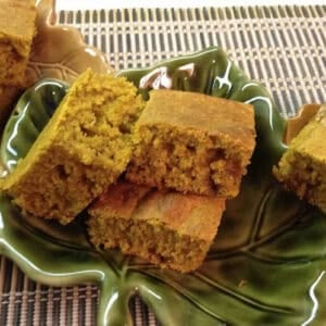 Six square slices of Pumpkin Cornbread in a festive fall leaf-shaped dish