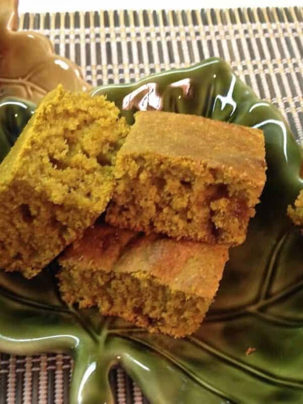 Six square slices of Pumpkin Cornbread in a festive fall leaf-shaped dish