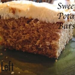 A square slice of a sweet potato bar topped with white icing on a small plate