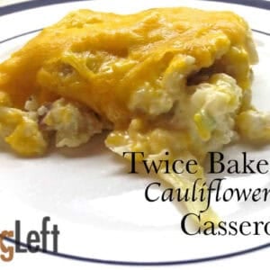 Twice Baked Cauliflower topped with a layer of melted cheese on a plate