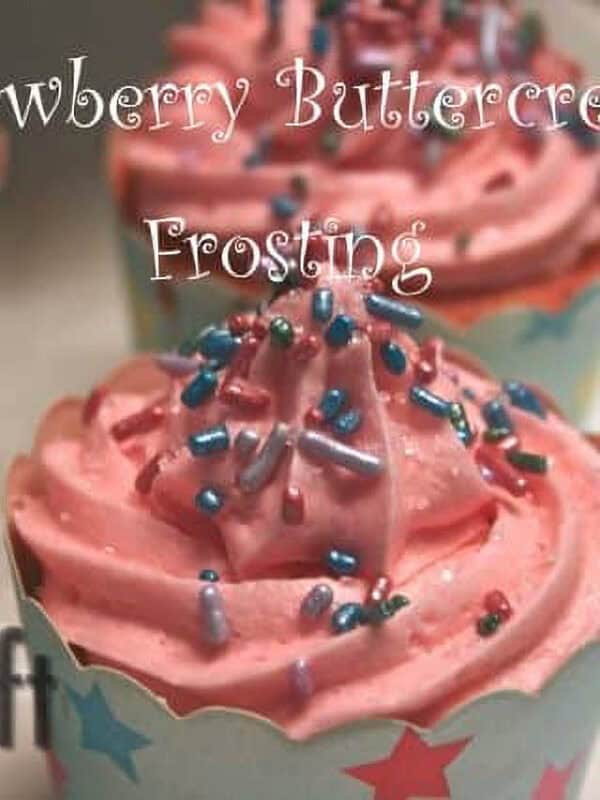 Four cupcakes topped with Strawberry Buttercream Frosting and purple, blue, and pink sprinkles