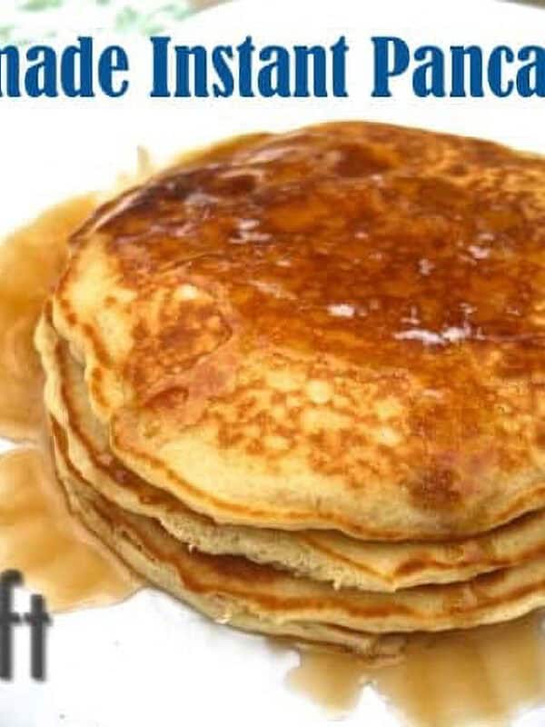 A stack of three pancakes topped with syrup on a plate