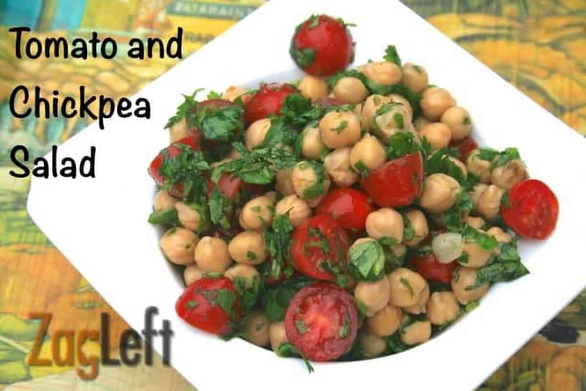 Tomato and Chickpea Salad topped with cilantro in a square bowl