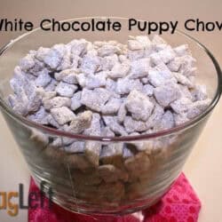 Blue and white sugar-coated puppy chow snack in glass bowl, perfect for sharing on food and travel blogs.