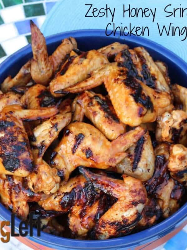 Overhead view of a large serving dish of Zesty Honey Sriracha Grilled Chicken Wings