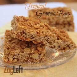 Two Tropical Granola Bars on a small plate with two more bars in the background