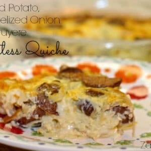 A slice of Roasted Potato, Caramelized Onion and Gruyere Crustless Quiche on a plate with the remainder of the quiche in the background