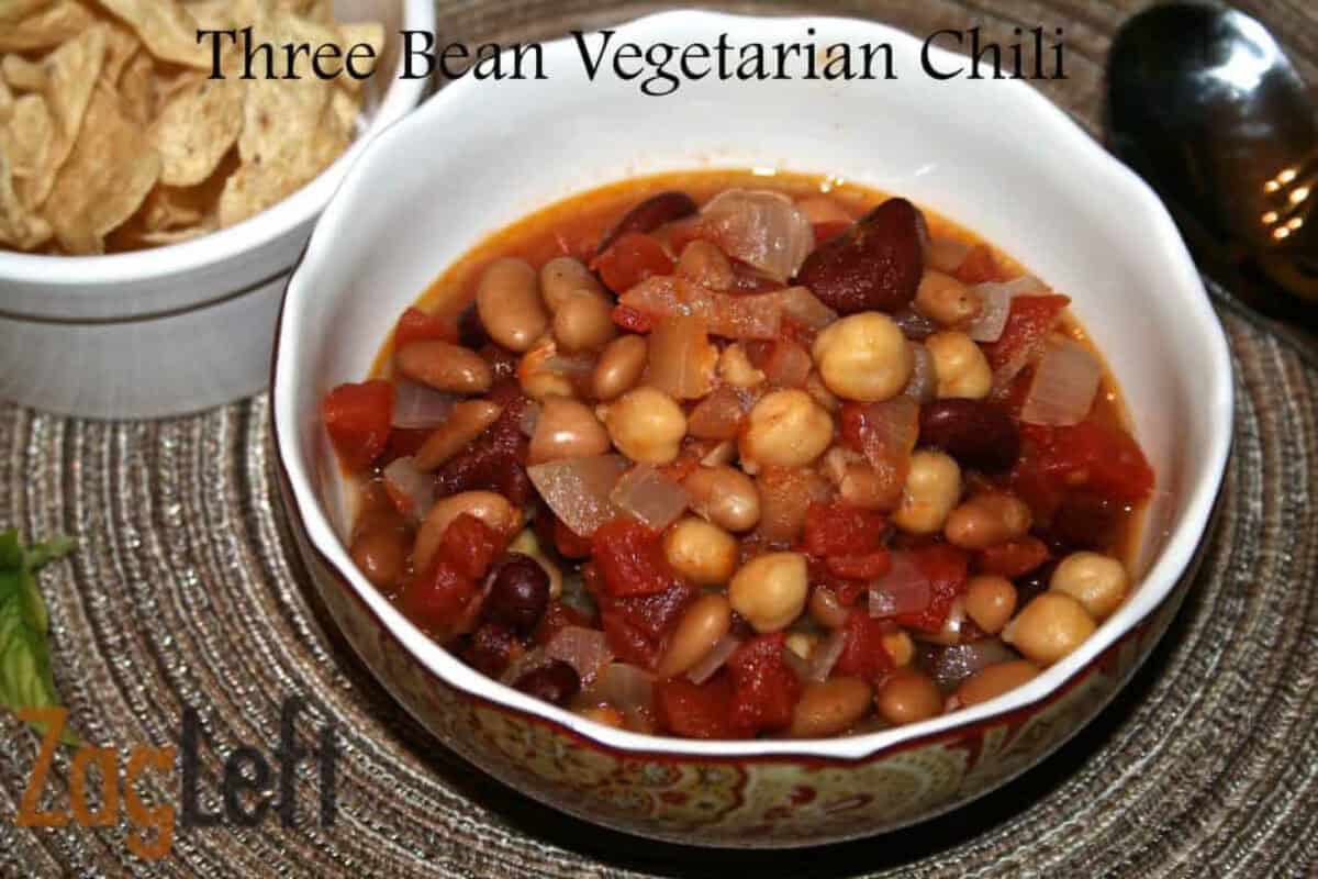 Three Bean Vegetarian Chili from Zagleft A bowl of Three Bean Vegetarian Chili next to a ramekin of tortilla chips and a spoon