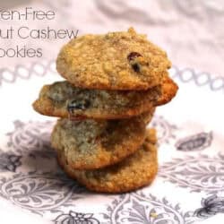 A stack of four Gluten Free Coconut Cashew Cookies on a plate