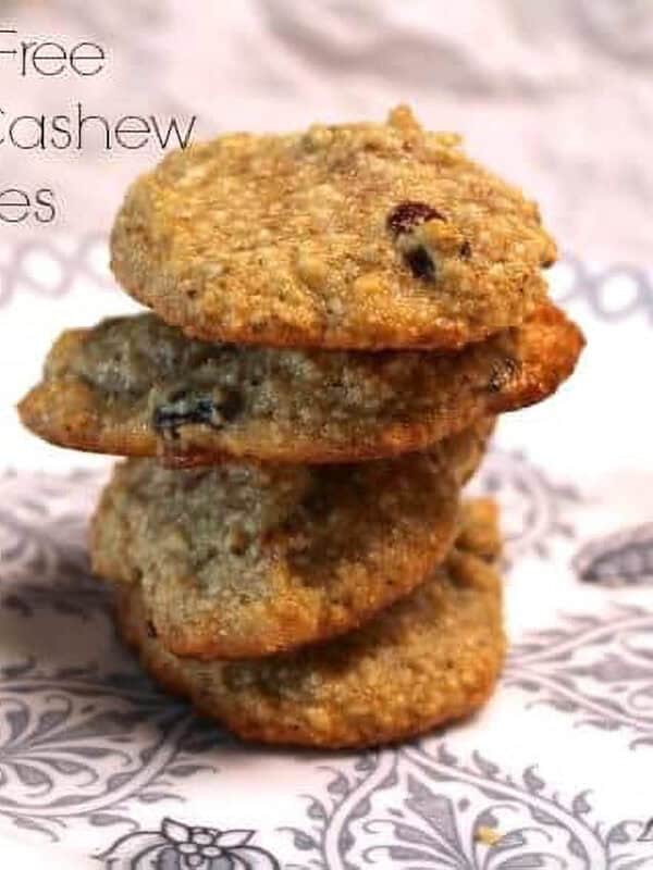 A stack of four Gluten Free Coconut Cashew Cookies on a plate