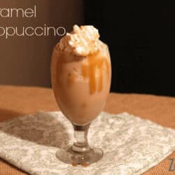 Caramel Frappuccino in a tall glass with whipped cream on top.