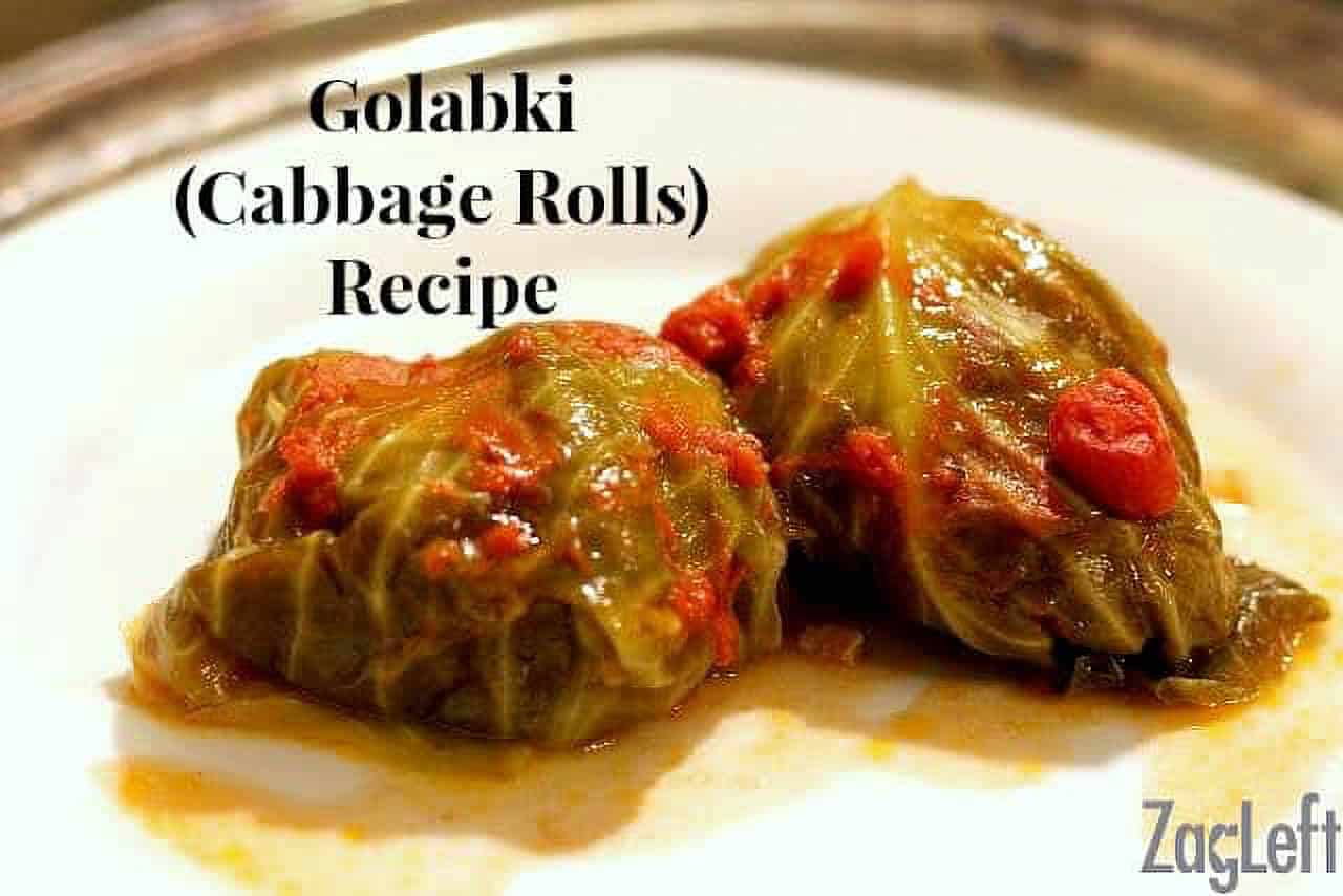 Two Golabki (Stuffed Cabbage Rolls) topped with crushed tomatoes on a plate