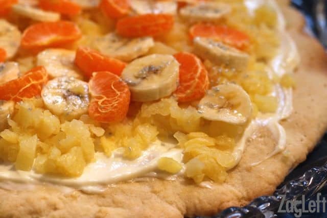 A closeup of Pineapple Shortbread Pizza topped with banana slices and slices of Mandarin oranges