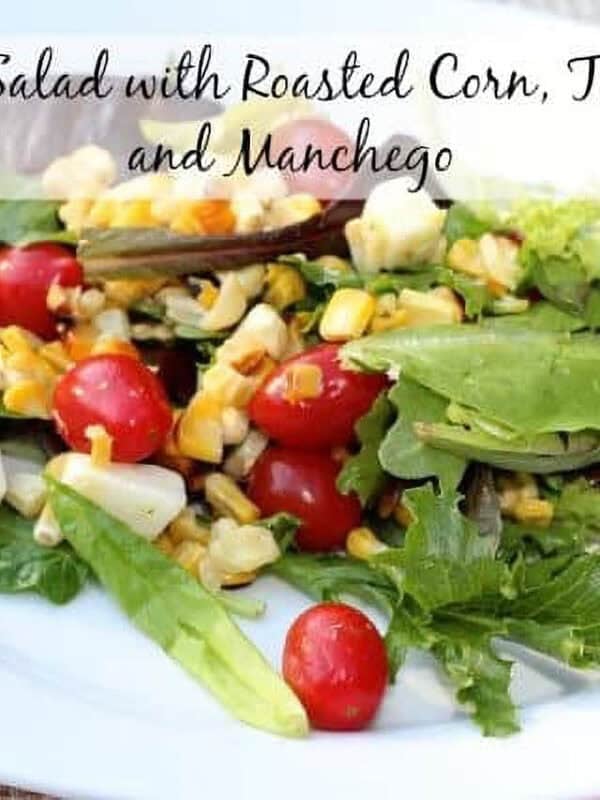 Spring Salad with Roasted Corn, cherry Tomatoes and Manchego on a plate