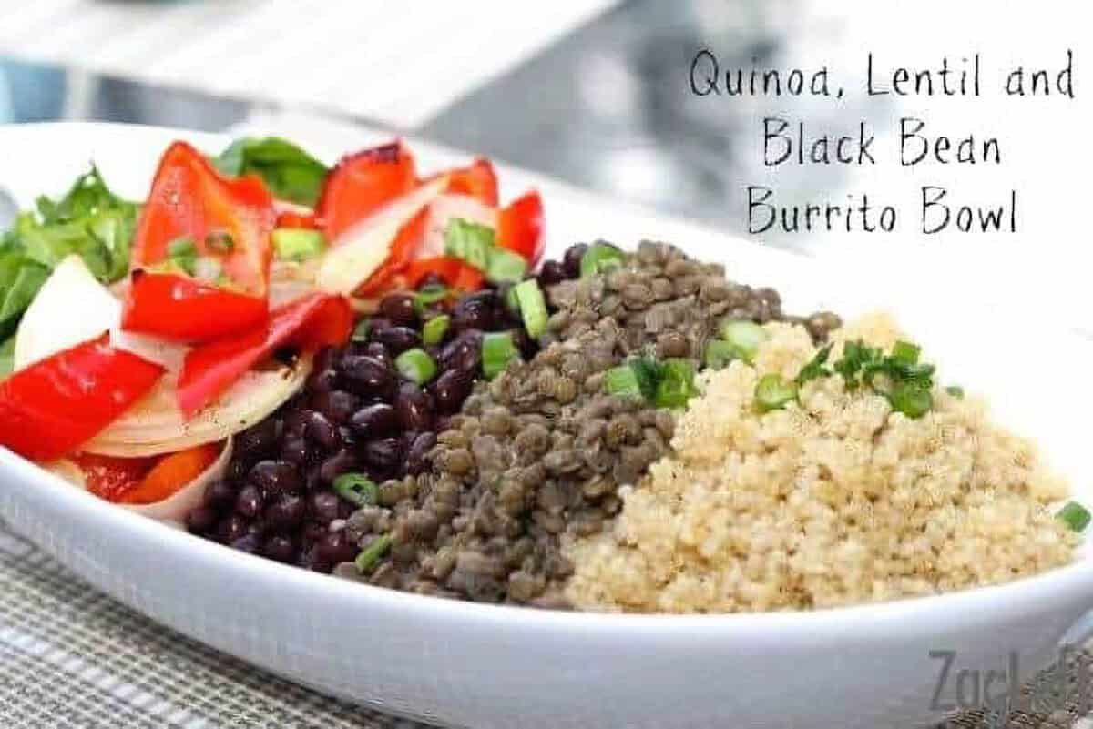 Quinoa, Lentils, Black Beans, baby spinach, and roasted red peppers and onions in a large serving dish