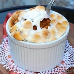 Sweet Potato with marshmallows on top in a ramekin with a fork in it.