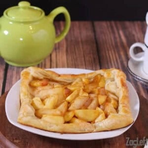 Apple and Pear Galette on a large plate next to a tea kettle