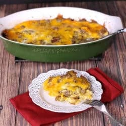 A scoop of Breakfast Casserole on a small plate with a fork next to the remainder of the casserole in a baking dish