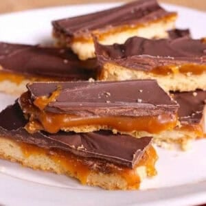 Homemade Twix Bars stacked on a large plate