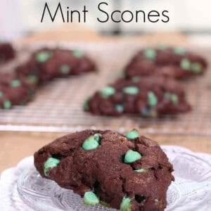A Double Chocolate Mint Scone on a small plate with scones on a cooling rack in the background