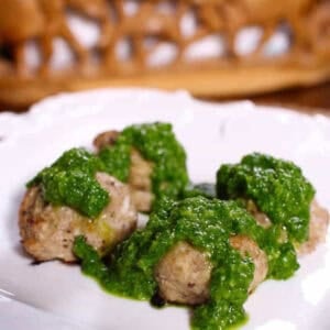 Four Turkey Meatballs topped with Chimichurri on a large plate