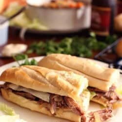 Two halves of a Roast Beef Po-boy on a large plate