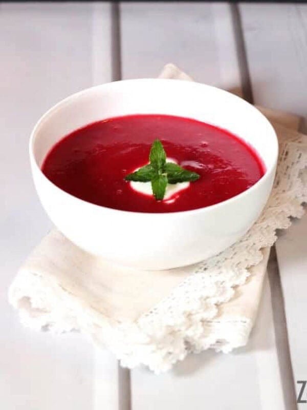 Borscht soup in a bowl topped with a dollop of sour cream